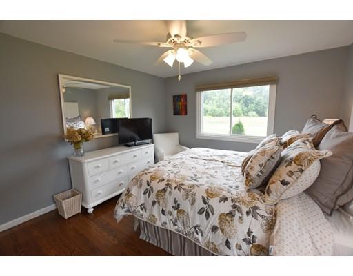 306 Bolton Road Lancaster, MA 01523 - Photo 24 of 30 a bedroom with a bed and a chandelier