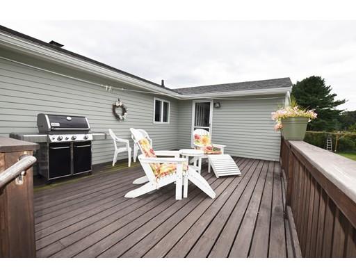 306 Bolton Road Lancaster, MA 01523 - Photo 30 of 30 a view of a roof deck with table and chairs a barbeque with wooden floor and fence