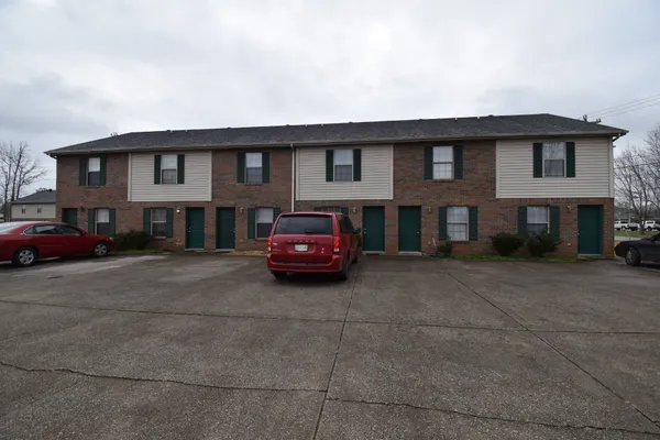 a couple of cars parked in front of a house