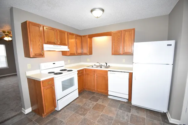 a kitchen with a refrigerator sink stove and a refrigerator