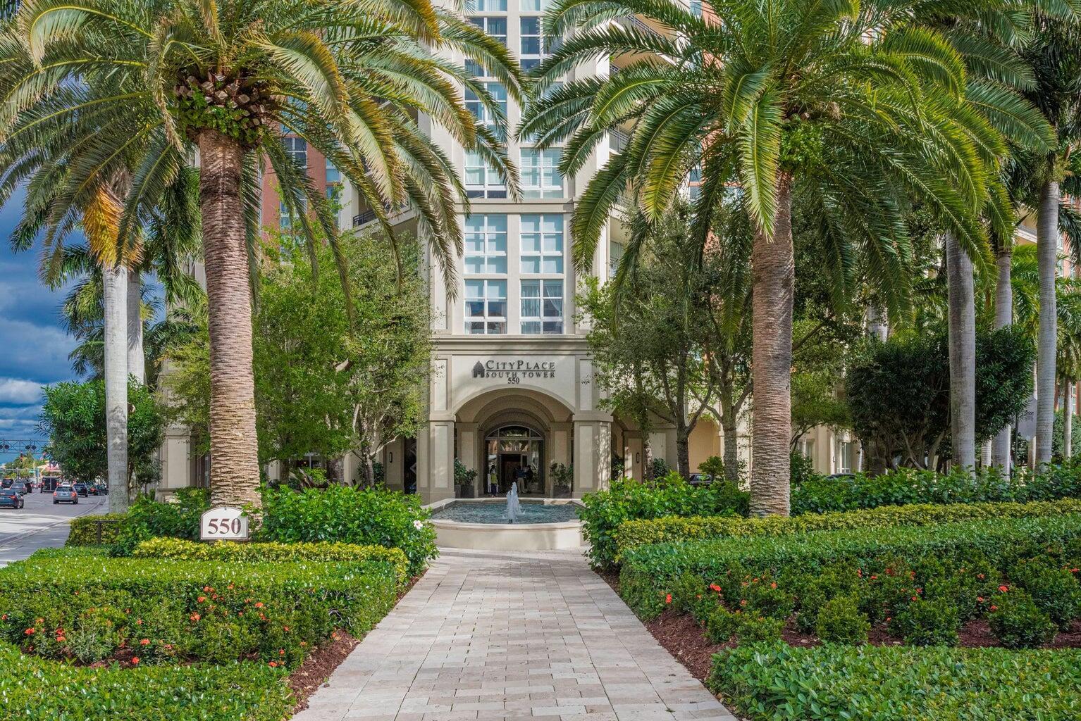 550 Okeechobee Boulevard, Unit 1718 West Palm Beach, FL 33401 - Photo 1 of 13 a view of a house with a yard and potted plants