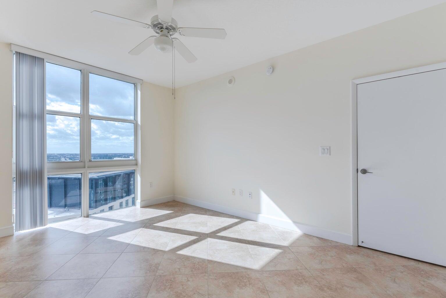 550 Okeechobee Boulevard, Unit 1718 West Palm Beach, FL 33401 - Photo 7 of 13 a view of an empty room with a window and a kitchen