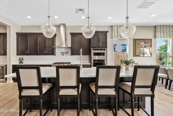 a large kitchen with lots of counter space and furniture