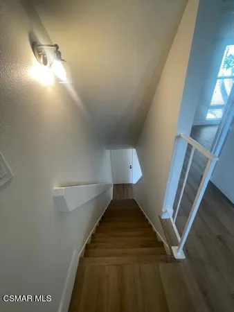 a bathroom with a granite countertop sink toilet a mirror and shower