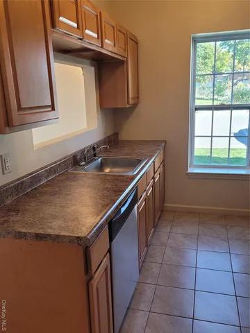 a kitchen with a sink a stove top oven and cabinets