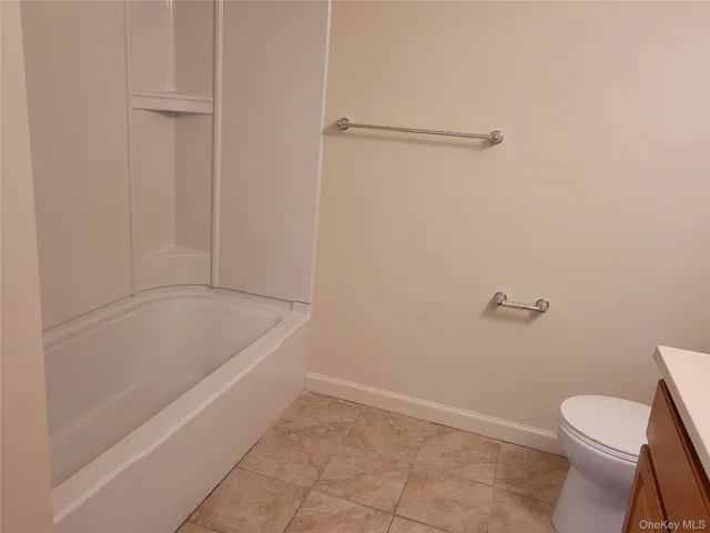a bathroom with a bathtub and toilet