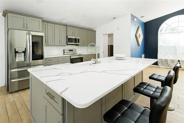 a kitchen with a stove a refrigerator and a sink