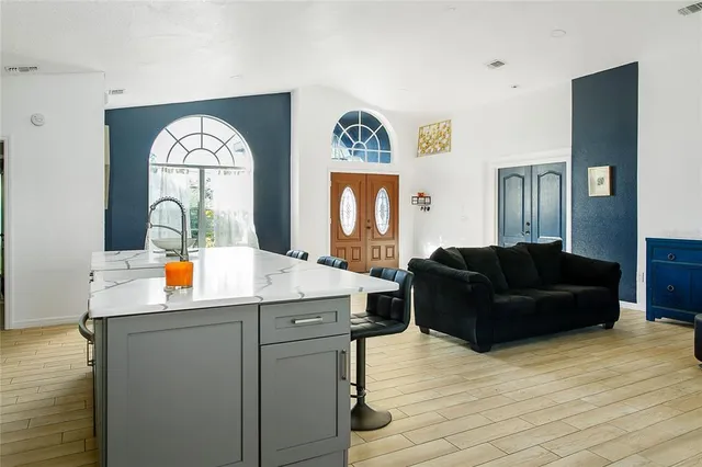 a living room with furniture and a mirror