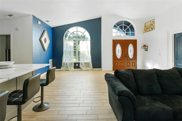 a living room with furniture and a wooden floor