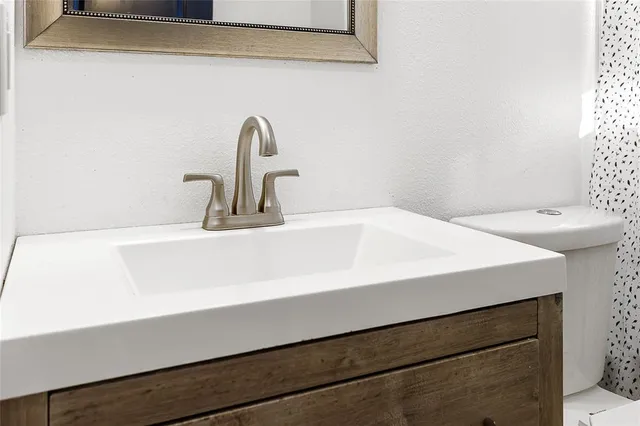 a close view of sink and a cabinet