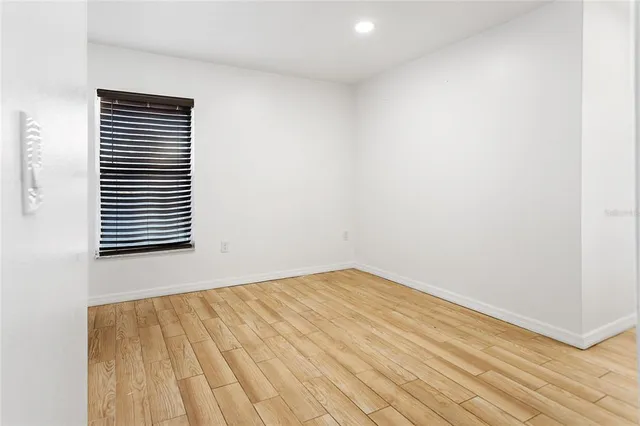 a view of a room with wooden floor and a window