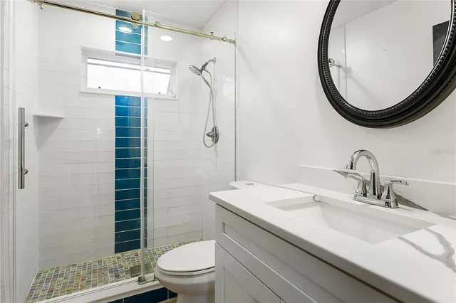 a bathroom with a sink a toilet and a mirror