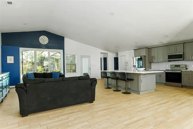 a living room with furniture and large windows