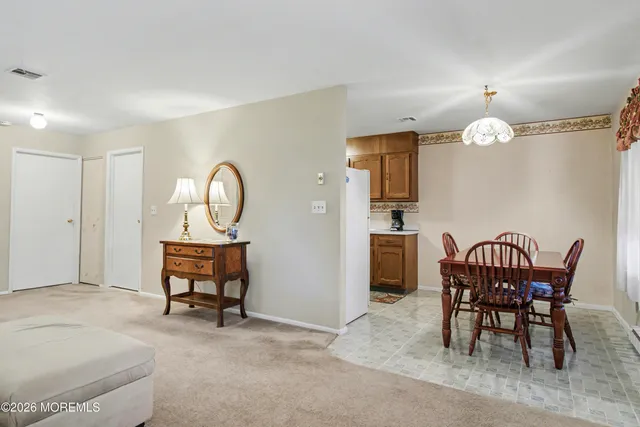 a view of a a dining room with furniture window and wooden floor