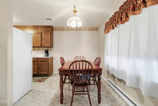 a view of a dining room with furniture and chandelier