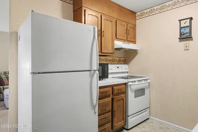 a white refrigerator freezer and a stove