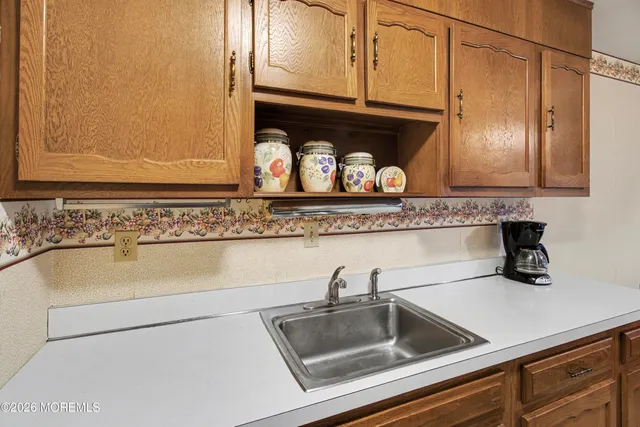 a kitchen with granite countertop a sink and cabinets