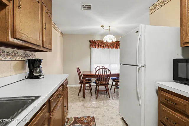 a table with chairs and a stove top oven