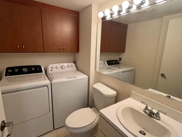 a bathroom with a double vanity sink mirror and shower