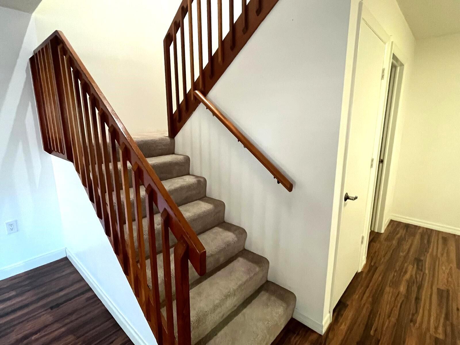 7 Amherst Court, Unit A Royal Palm Beach, FL 33411 - Photo 19 of 45 a view of entryway with wooden floor and stairs