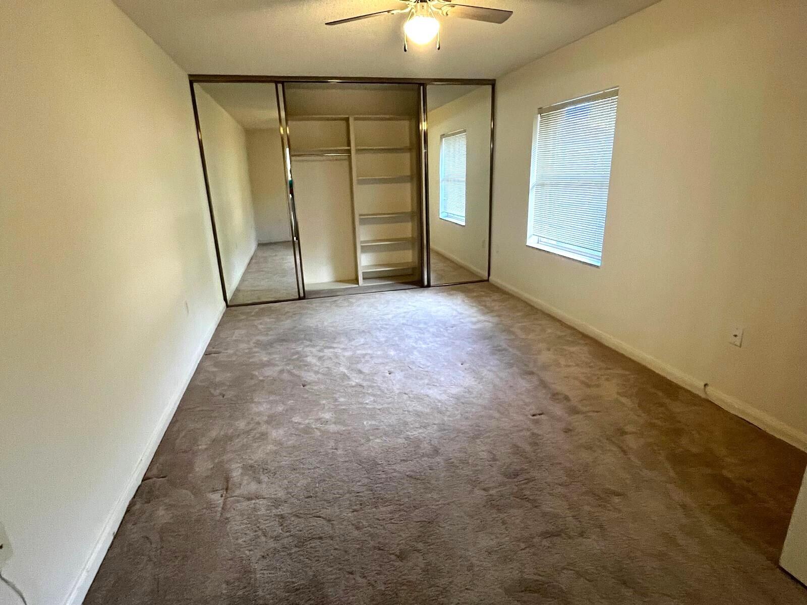 7 Amherst Court, Unit A Royal Palm Beach, FL 33411 - Photo 20 of 45 an empty room with a empty space and a window