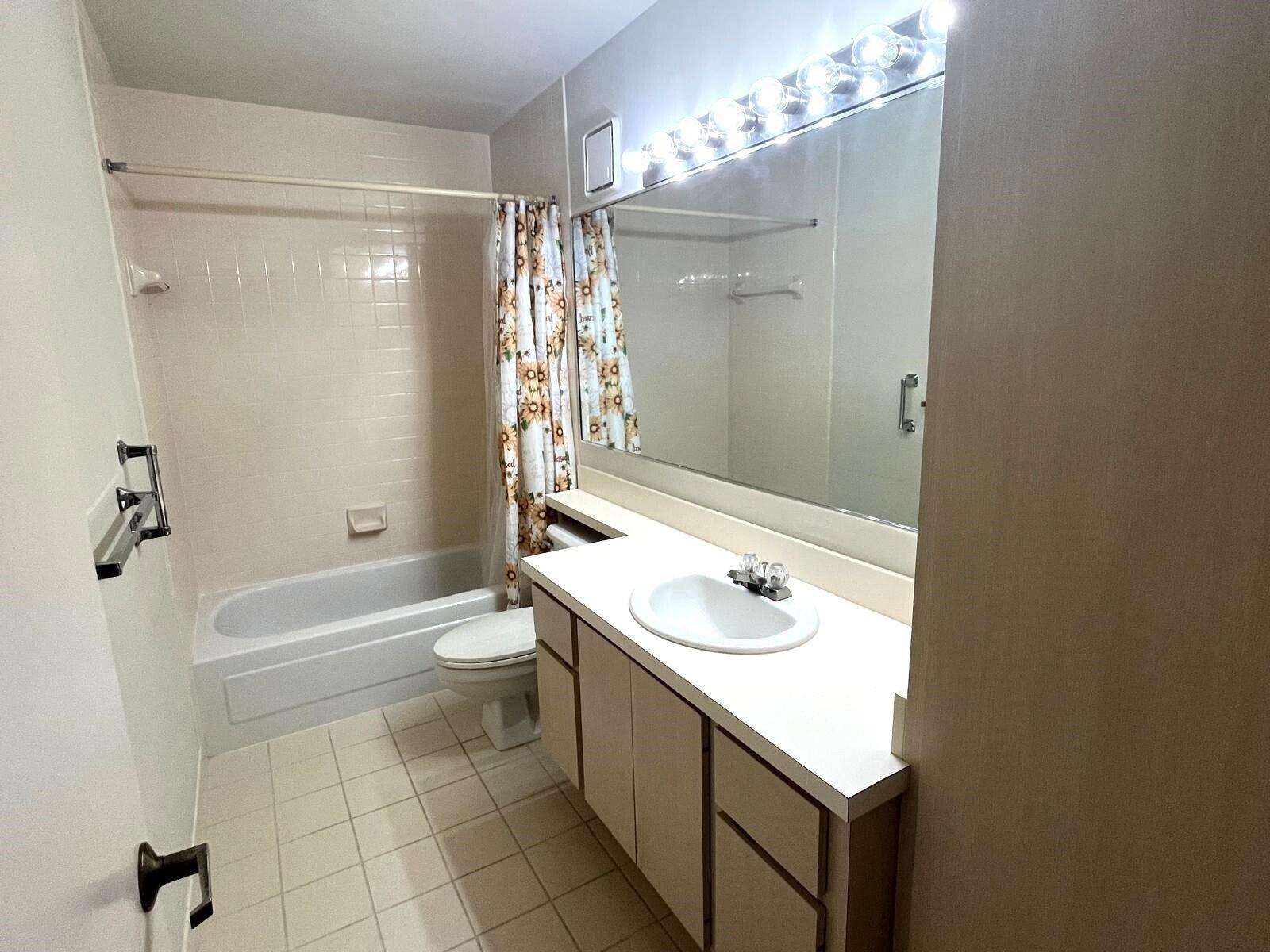 7 Amherst Court, Unit A Royal Palm Beach, FL 33411 - Photo 22 of 45 a bathroom with a sink a toilet and shower