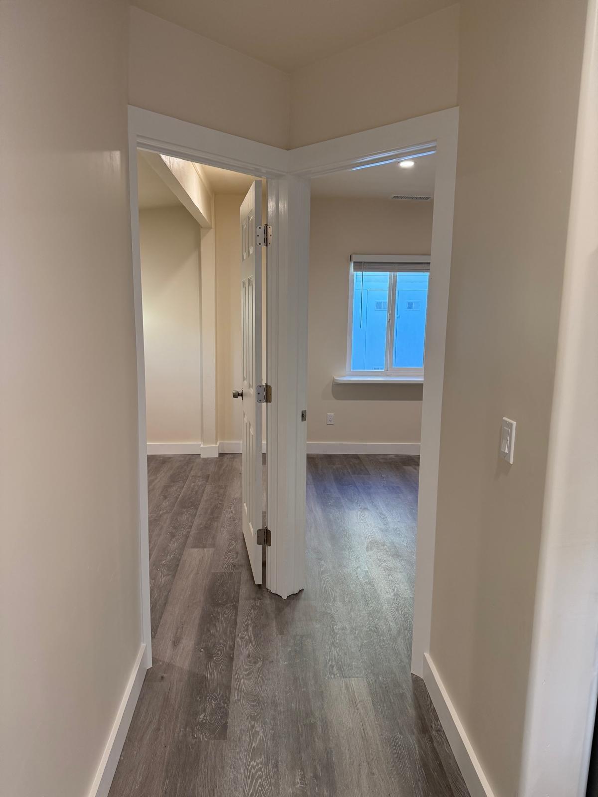 4946 8th Street, Unit B Carpinteria, CA 93013 - Photo 10 of 20 an empty room with wooden floor and windows