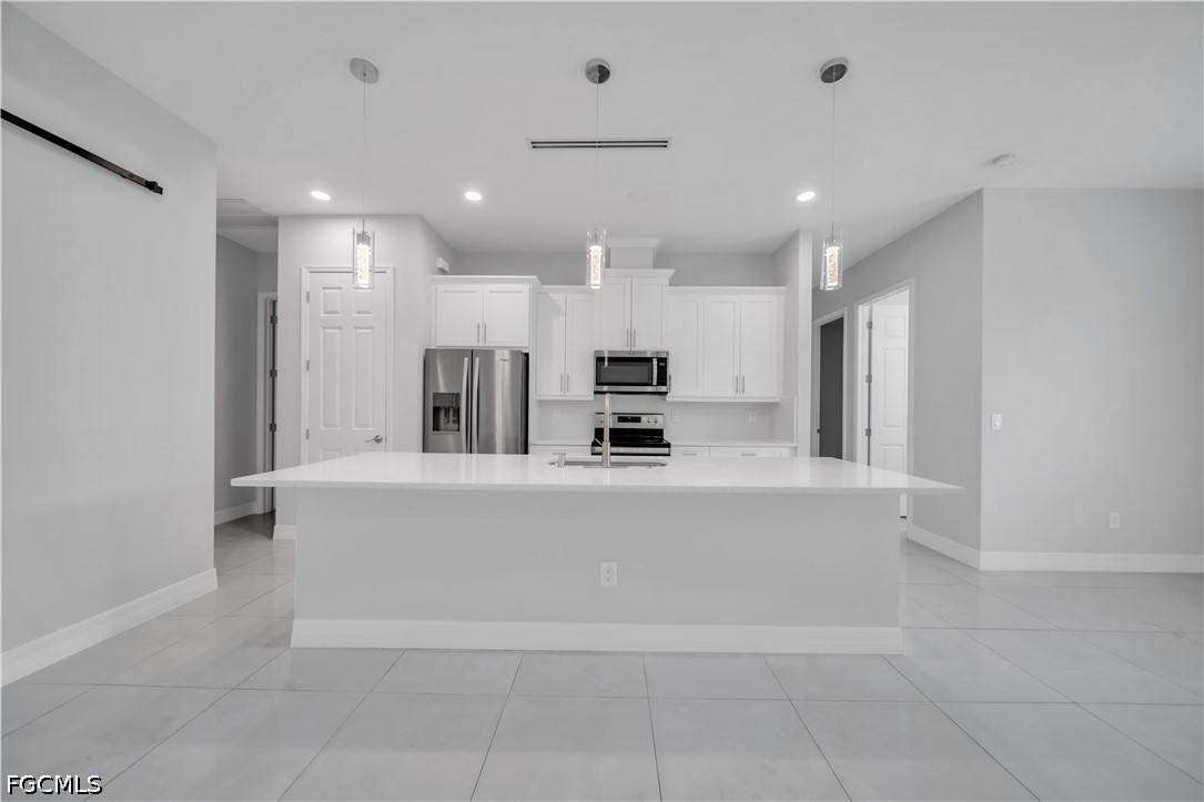 3509 38th Street Southwest Lehigh Acres, FL 33976 - Photo 11 of 47 a view of kitchen with center island and stainless steel appliances
