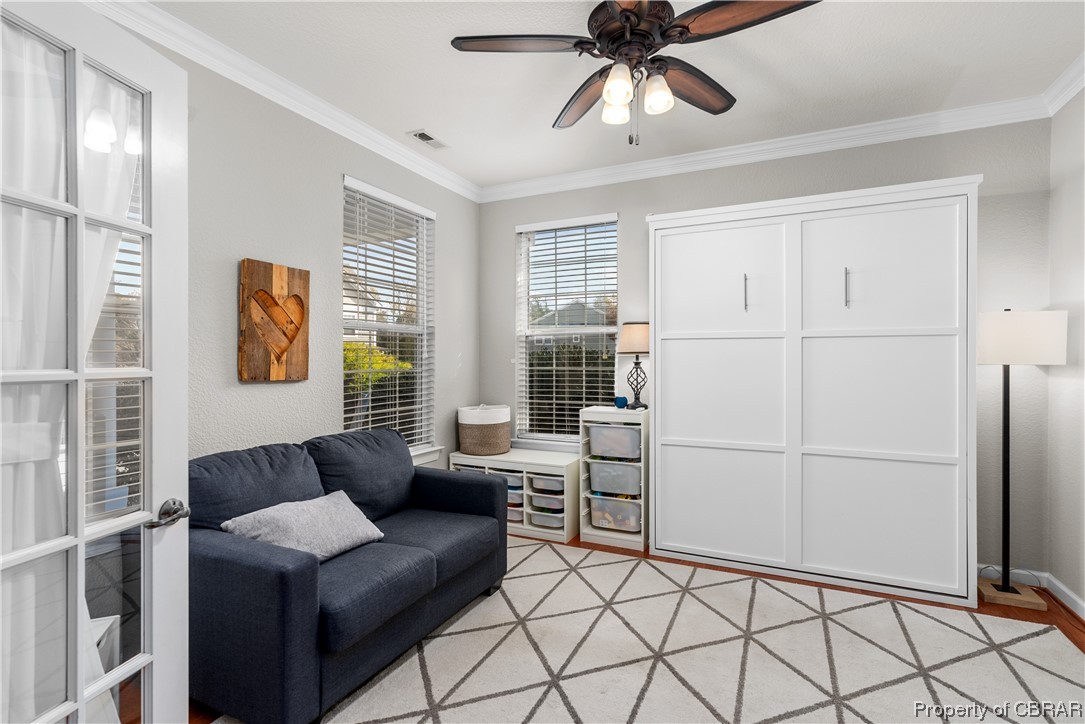 2124 Piedmont Road Suffolk, VA 23435 - Photo 7 of 41 Living area featuring crown molding and ceiling fan
