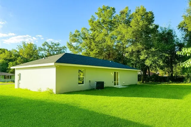a view of a back yard of the house with a small yard