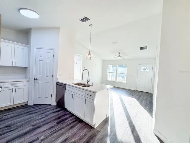 a kitchen with a sink stove and cabinets