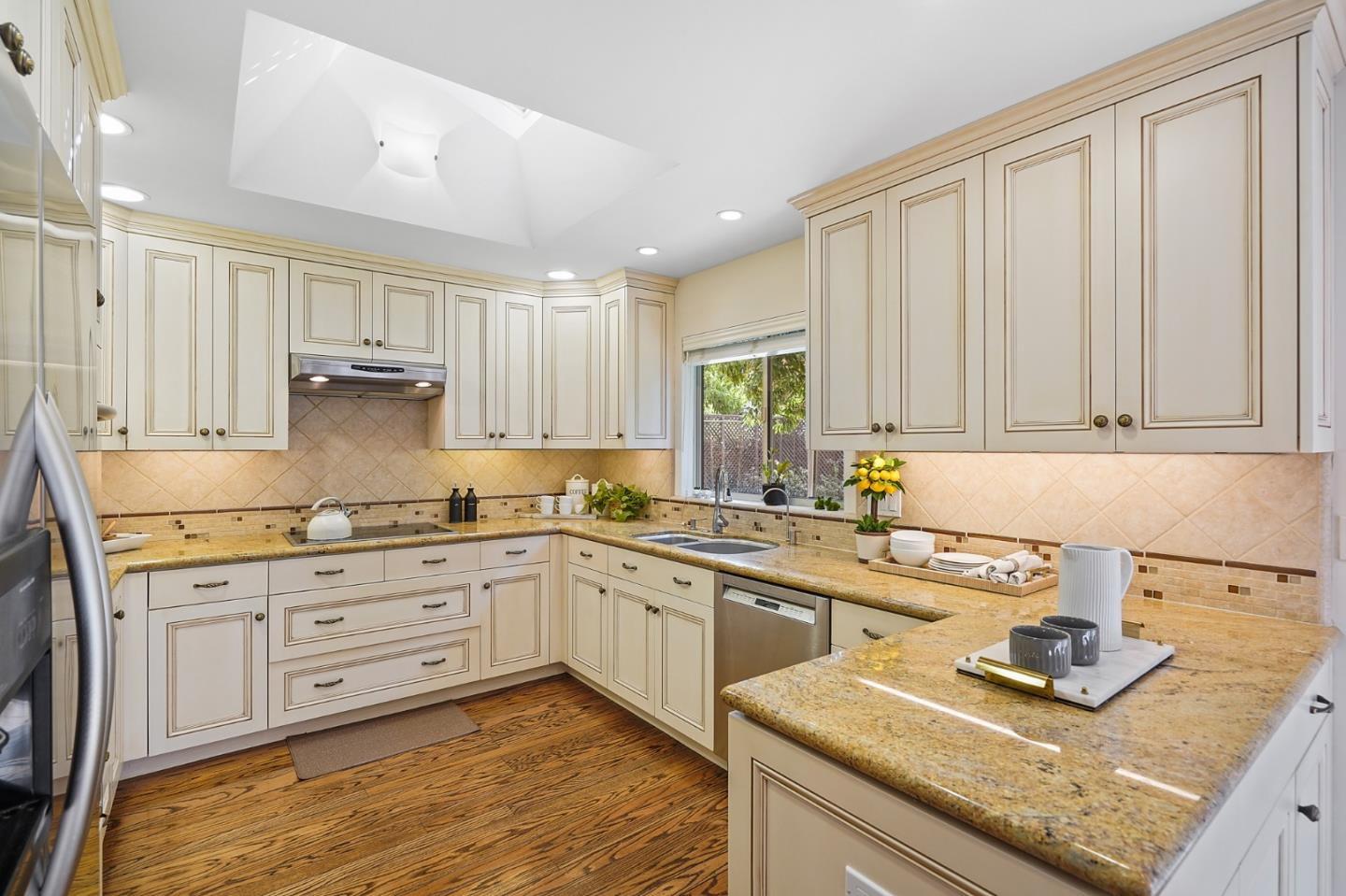 190 Pine Lane Los Altos, CA 94022 - Photo 8 of 26 a kitchen with granite countertop white cabinets sink and stainless steel appliances