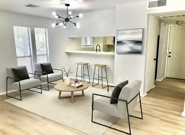 a living room with furniture and a chandelier