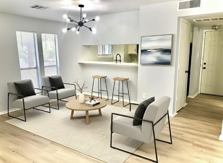 9601 Walnut Street, Unit 5101 Dallas, TX 75243 - Photo 2 of 7 a living room with furniture and a chandelier