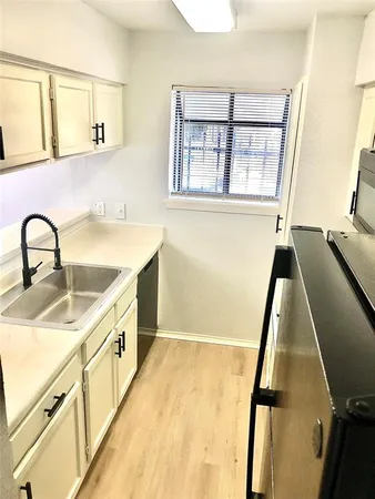 a view of a kitchen with sink and dishwasher