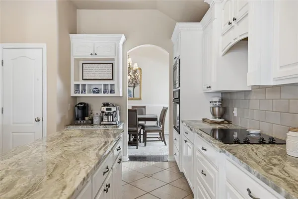 a kitchen with stainless steel appliances granite countertop a sink and cabinets
