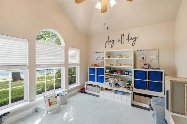 a bedroom with furniture and a large window