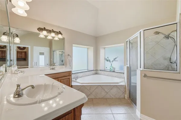 a spacious bathroom with a sink a bathtub and a mirror