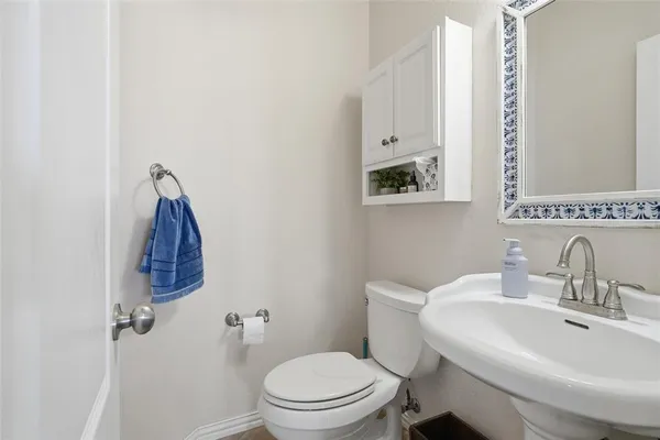 a bathroom with a sink toilet and mirror