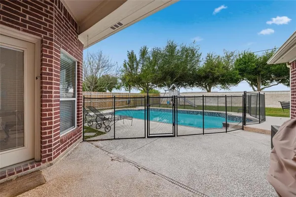 a view of a house with swimming pool and sitting area