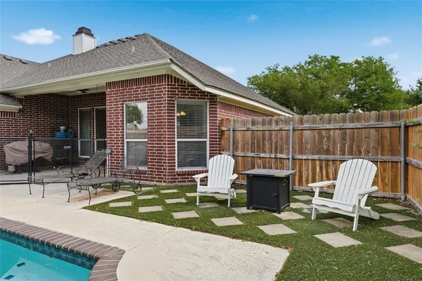 a view of a house with a backyard porch and sitting area