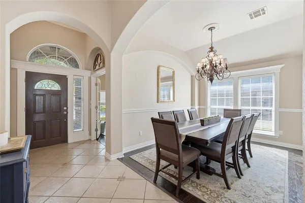a view of a dining room with furniture and chandelier