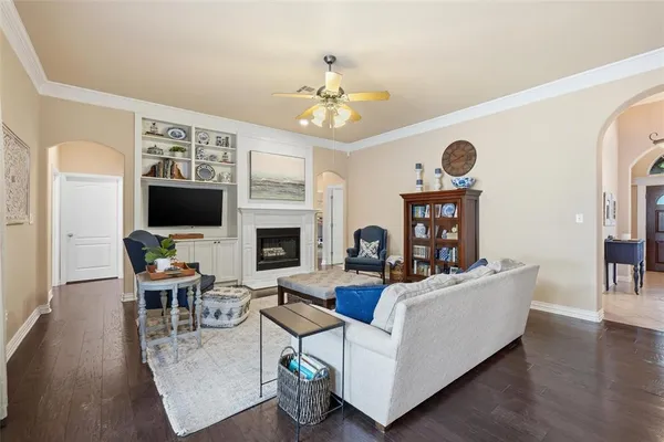 a living room with fireplace furniture and a flat screen tv