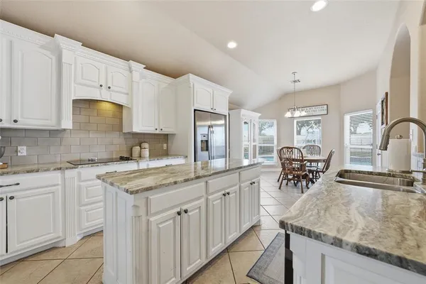 a kitchen with cabinets appliances and a counter space