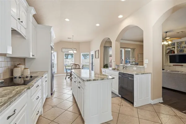 a kitchen with stainless steel appliances granite countertop a sink and cabinets