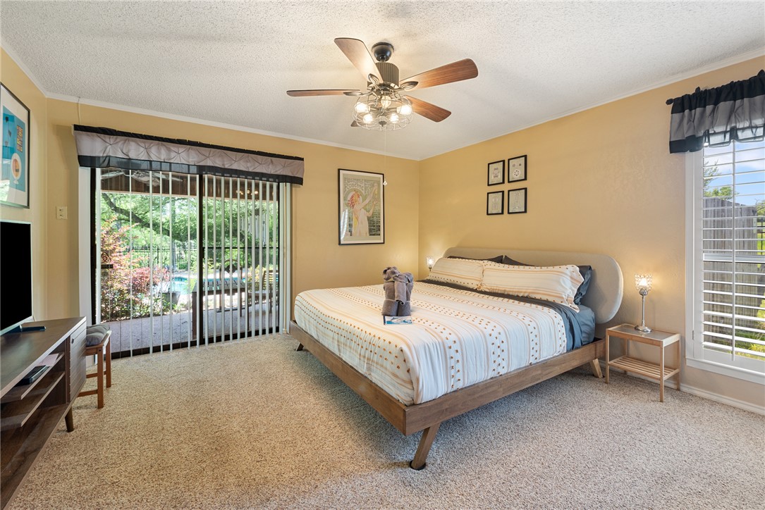 1309 Rock Dam Road Marlin, TX 76661 - Photo 13 of 50 Bedroom with a textured ceiling, ceiling fan, crown molding, and carpet