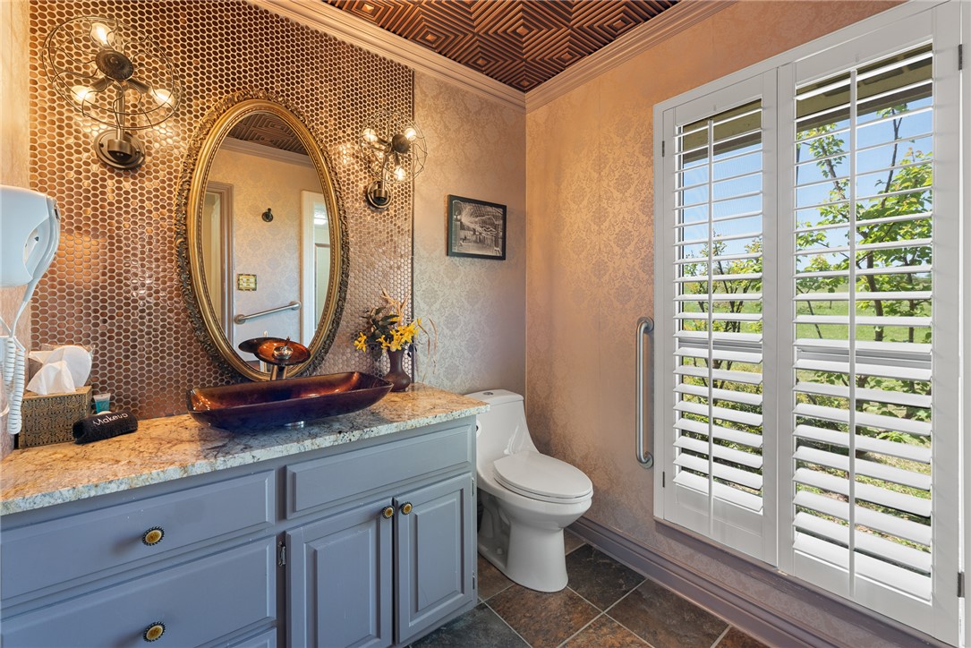 1309 Rock Dam Road Marlin, TX 76661 - Photo 15 of 50 Bathroom with toilet, a textured wall, crown molding, vanity, and stone finish flooring