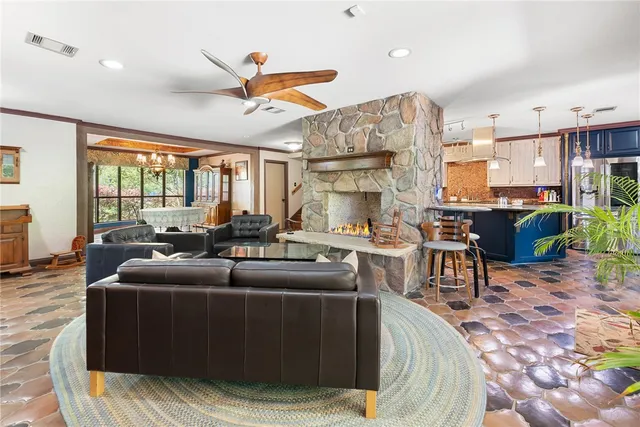 a kitchen with stainless steel appliances granite countertop a sink a stove and a wooden floors