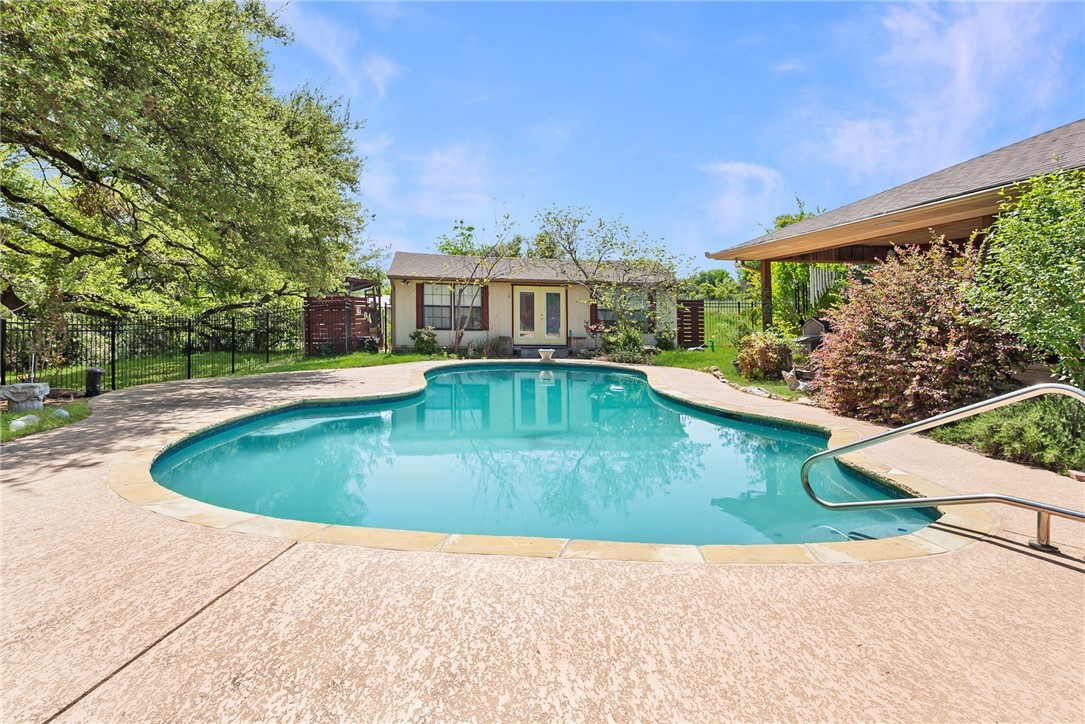 1309 Rock Dam Road Marlin, TX 76661 - Photo 2 of 50 View of swimming pool with a patio area, fence, an outbuilding, a fenced in pool, and a storage structure