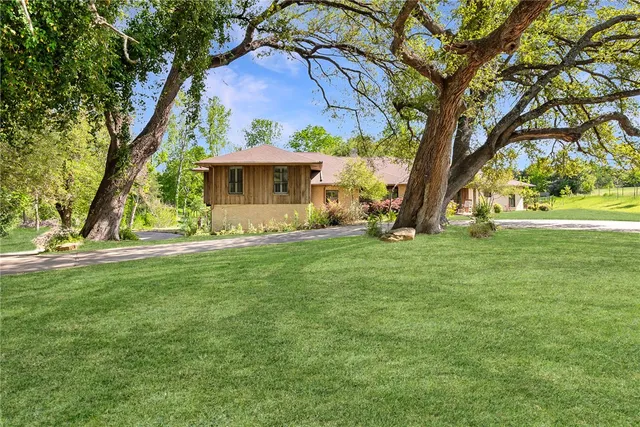 a front view of house with yard and green space